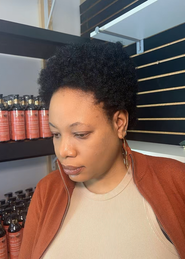Woman standing in a store with shelves of products in the background